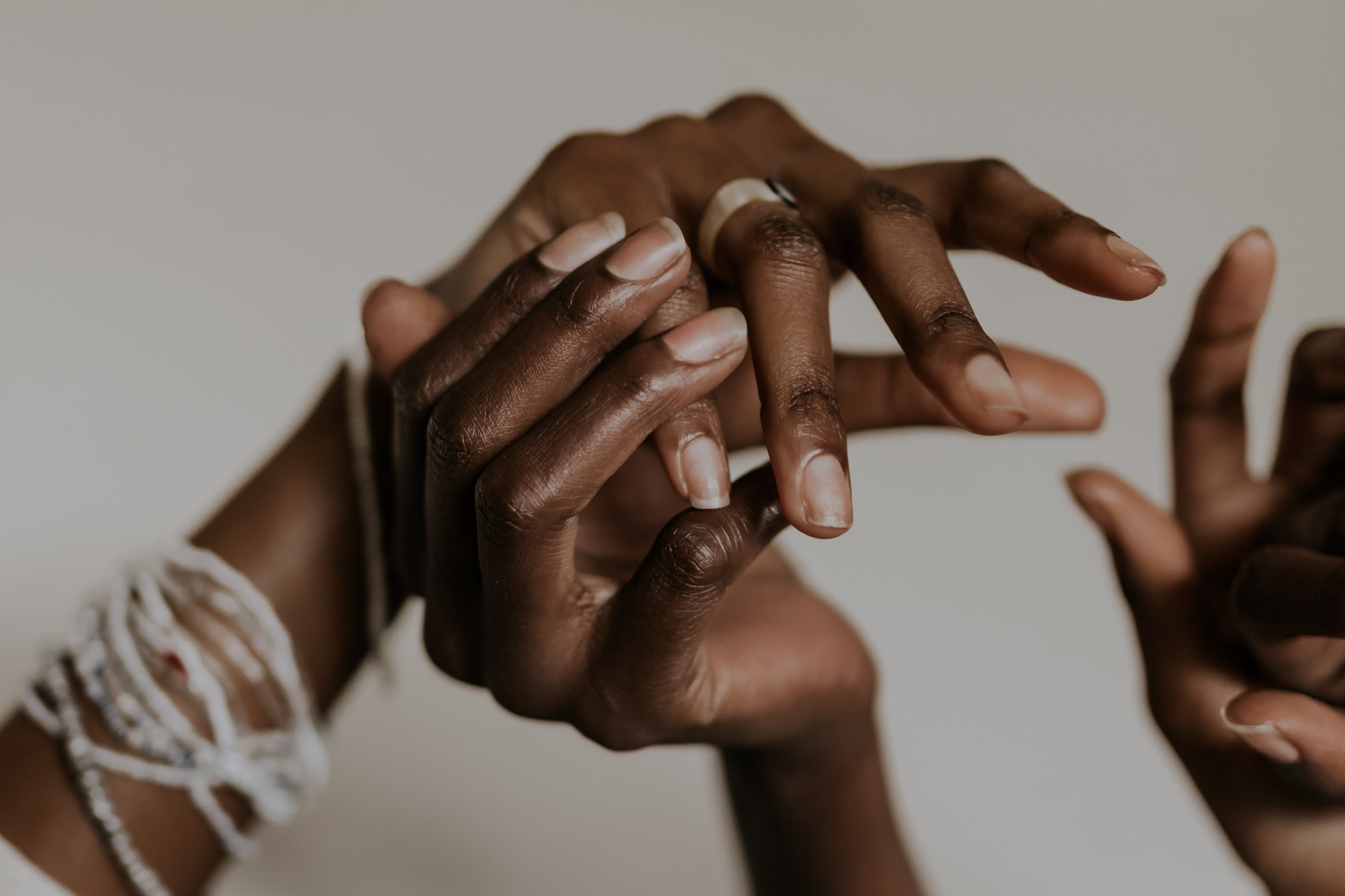women holding and touching hands